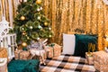 Christmas photo zone with a Christmas tree, garland, New Year`s decor and gifts. Christmas and New Year celebration concept