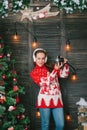 Christmas photographer girl in red sweater with camera in hands.