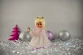 Christmas photography picture with old vintage hand made fairy tree topper and glitter tree decoration baubles in background Royalty Free Stock Photo