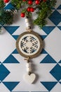 Christmas pine border and wooden snow star ornament, decorated with red berries on blue and white geometric background, space for Royalty Free Stock Photo