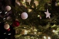 Christmas pine tree with white stars, balls and lights.