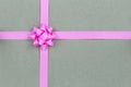 Christmas Pink Bow and ribbon on brown paper background Royalty Free Stock Photo