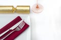 Christmas place setting with gold cracker Royalty Free Stock Photo