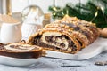 Christmas poppy seed cake, sliced poppy seed cake covered with icing and decorated with raisins and walnuts. Traditional Christmas Royalty Free Stock Photo