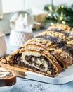 Christmas poppy seed cake, sliced poppy seed cake covered with icing and decorated with raisins and walnuts. Traditional Christmas Royalty Free Stock Photo