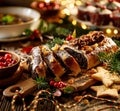 Christmas poppy seed cake, sliced poppy seed cake covered with icing and decorated with raisins and walnuts on the holiday table. Royalty Free Stock Photo