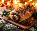 Christmas poppy seed cake, traditional baking in a festive arrangement with flickering lights Royalty Free Stock Photo