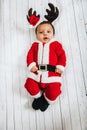 Christmas portrait of adorable newborn baby wearing Santa Claus` outfit Royalty Free Stock Photo