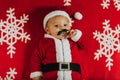 Christmas portrait of adorable newborn baby wearing Santa Claus` outfit Royalty Free Stock Photo