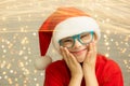 Christmas Portrait of a beautiful girl with Down syndrome in a hat of Santa Claus Royalty Free Stock Photo