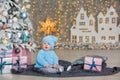 Christmas portrait of cute little newborn baby boy, dressed in christmas clothes and wearing santa hat, studio shot, winter time Royalty Free Stock Photo