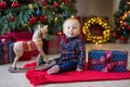 Christmas portrait of cute little newborn baby boy, dressed in christmas clothes and wearing santa hat, studio shot, winter time Royalty Free Stock Photo