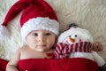 Christmas portrait of cute little newborn baby boy, wearing santa hat Royalty Free Stock Photo