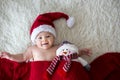 Christmas portrait of cute little newborn baby boy, wearing santa hat Royalty Free Stock Photo