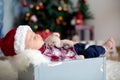 Christmas portrait of cute sleeping newborn baby boy, dressed in Royalty Free Stock Photo