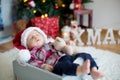 Christmas portrait of cute sleeping newborn baby boy, dressed in Royalty Free Stock Photo