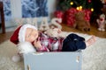 Christmas portrait of cute sleeping newborn baby boy, dressed in Royalty Free Stock Photo