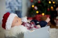 Christmas portrait of cute sleeping newborn baby boy, dressed in Royalty Free Stock Photo