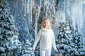 Christmas portrait of happy blonde child girl ndoor studio, snowy winter decorated tree on background. New Year Holidays