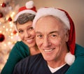 Christmas, portrait and happy senior couple with love, care and support together in a home on holiday. Tree, retirement Royalty Free Stock Photo