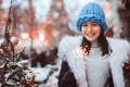 christmas portrait of happy woman with burning firelight walking outdoor in snowy winter city Royalty Free Stock Photo