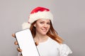 Christmas portrait of perfect woman in red Santa hat showing smartphone display Royalty Free Stock Photo