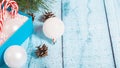 Christmas postcard design. Striped red and white Christmas decorations, balls, candy canes on blue wooden background. Flat lay, Royalty Free Stock Photo