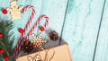 Christmas postcard design. Striped red and white Christmas decorations, balls, candy canes on blue wooden background. Flat lay, Royalty Free Stock Photo