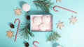 Christmas postcard design. Striped red and white Christmas decorations, balls, candy canes on light blue background. Flat lay, top Royalty Free Stock Photo