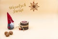 Christmas postcard with text Wesotych Swiat and a beige background, nuts, wooden candle and a funny gnome