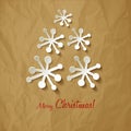 Christmas postcard Vector paper Snowflakes Christmas tree on a crumpled paper brown background. Royalty Free Stock Photo