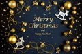 Christmas postcard with Xmas gold decoration, shiny balls, bells, deer and stars on black background Royalty Free Stock Photo