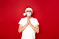 Christmas prayer of peaceful man about fulfillment of desires, health of loved ones, to put white T-shirt in xmas hat