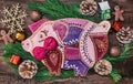Christmas preparations, cutting board in the form of pigs, fir branches, cones and decorations. New Year of the pig on the Chinese Royalty Free Stock Photo