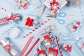 Christmas preparations - festive different gift boxes in red, blue and metallic color with silk ribbons, christmas tree on blue. Royalty Free Stock Photo