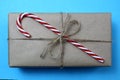Christmas present packed in brown paper with caramel cane Royalty Free Stock Photo