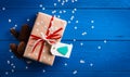 Christmas present with a red ribbon on a blue background with snowflakes Royalty Free Stock Photo