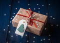 Christmas present with a red ribbon on a blue background with snowflakes Royalty Free Stock Photo