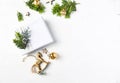 Christmas present, vintage decorations and fir twigs on white wooden background.