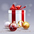 Christmas present, white, red and gold ball on a gray background Royalty Free Stock Photo