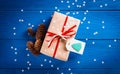 Christmas present with a red ribbon on a blue background with snowflakes Royalty Free Stock Photo