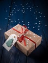 Christmas present with a red ribbon on a blue background with snowflakes Royalty Free Stock Photo