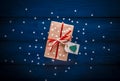 Christmas present with a red ribbon on a blue background with snowflakes Royalty Free Stock Photo