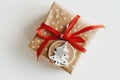 Christmas present wrapped in polka dot kraft paper, decorated with red ribbon and wooden tag Royalty Free Stock Photo