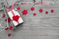 Christmas present wrapped in red paper on a wooden background