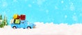Christmas presents on blue truck riding through a snowy forest Royalty Free Stock Photo