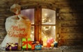 Christmas Presents and Candles at Window Pane Royalty Free Stock Photo