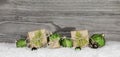 Christmas presents and green balls on wooden old grey background Royalty Free Stock Photo