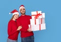 Christmas Presents. Happy Young Couple With Gift Boxes In Hands Royalty Free Stock Photo