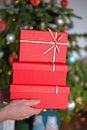 Christmas presents. Red gift boxes on Christmas tree background. gifts for the winter holidays. Christmas and New Years